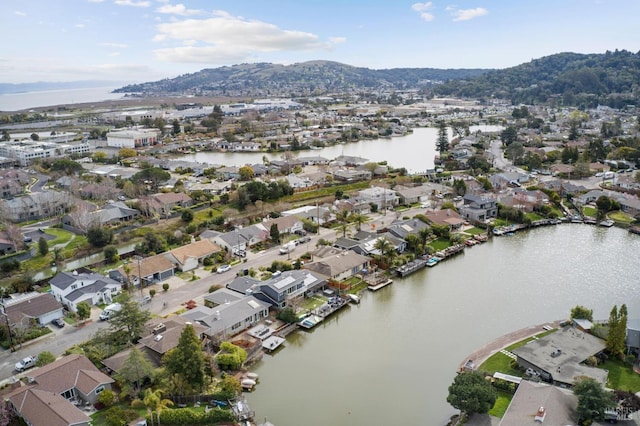 drone / aerial view featuring a residential view and a water and mountain view