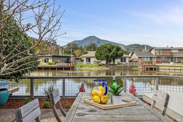 exterior space featuring a residential view and a water and mountain view