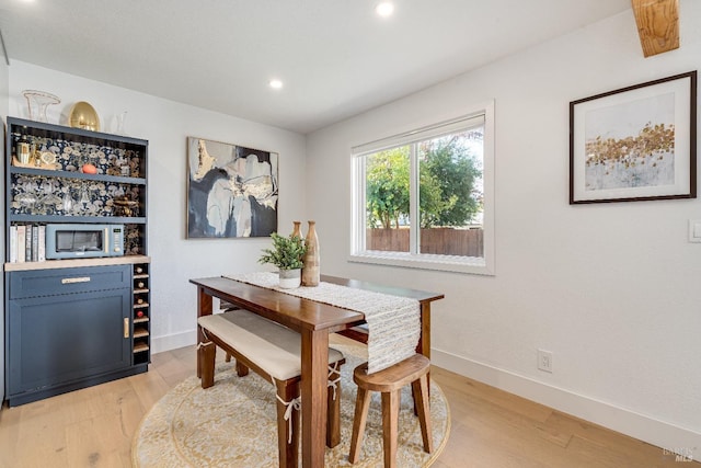 dining space featuring light wood-type flooring, baseboards, and recessed lighting