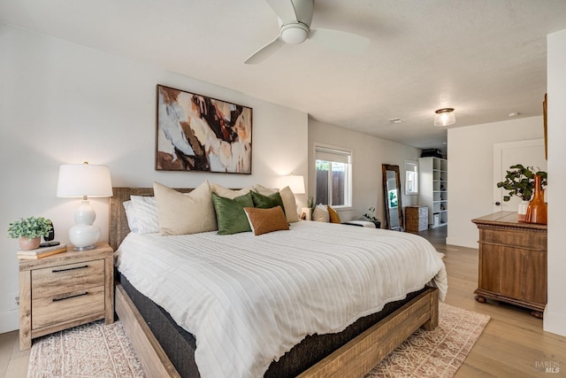 bedroom with ceiling fan and light wood-style floors