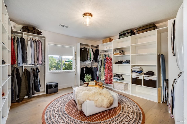 walk in closet with light wood finished floors and visible vents