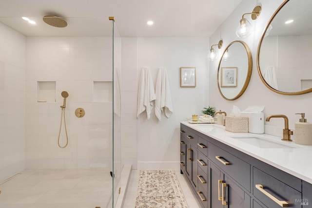 bathroom with double vanity, recessed lighting, a sink, a tile shower, and baseboards