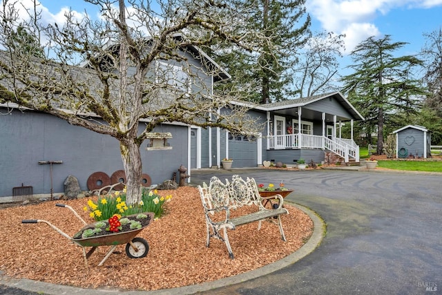 view of front of house featuring driveway and a porch