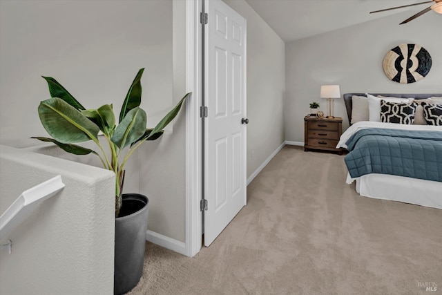 carpeted bedroom with ceiling fan and baseboards