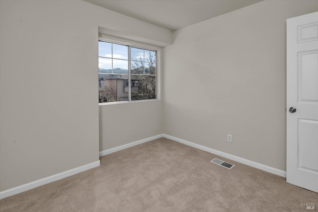 unfurnished room featuring carpet floors, baseboards, and visible vents