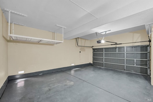 garage with a garage door opener and baseboards