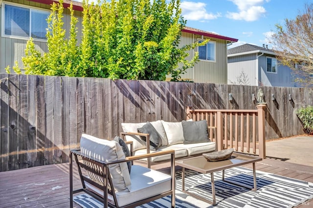 deck with outdoor lounge area and a fenced backyard