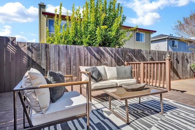 wooden terrace featuring an outdoor hangout area and a fenced backyard