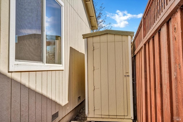 exterior space featuring an outbuilding, a storage unit, and crawl space