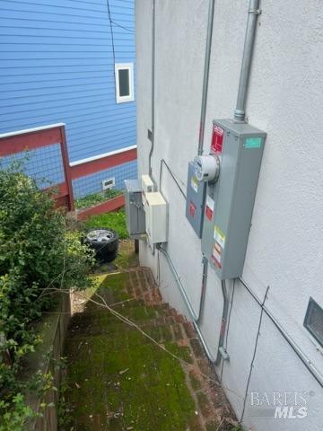 view of side of property with crawl space and stucco siding