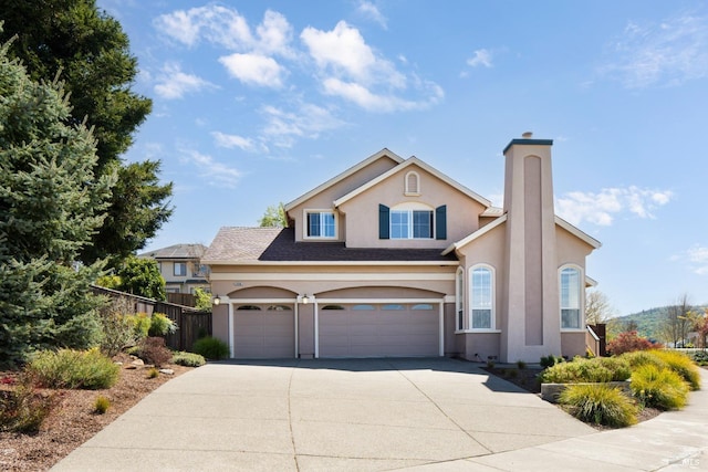 view of front facade featuring driveway, a chimney, stucco siding, fence, and a garage