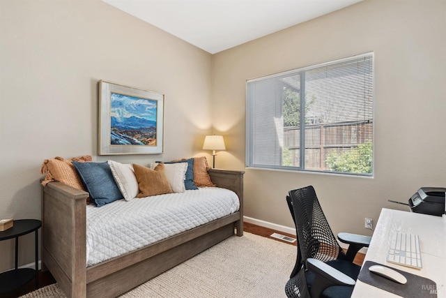 bedroom featuring baseboards and visible vents