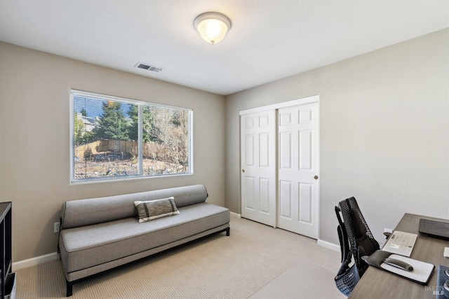 office featuring light colored carpet, visible vents, and baseboards