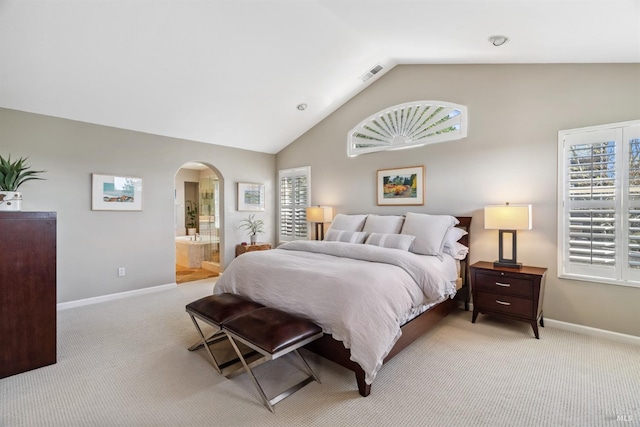 bedroom featuring vaulted ceiling, baseboards, arched walkways, visible vents, and light carpet