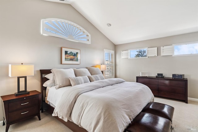 bedroom with baseboards, lofted ceiling, and light colored carpet