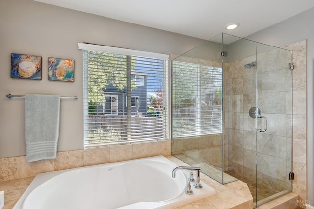 bathroom featuring a stall shower and a garden tub