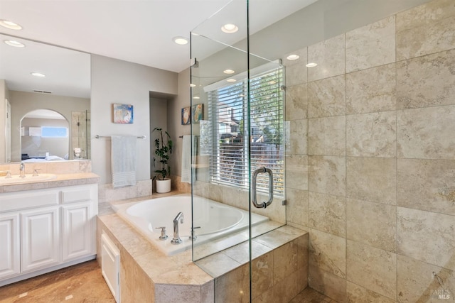 bathroom featuring a bath, ensuite bathroom, recessed lighting, vanity, and a stall shower