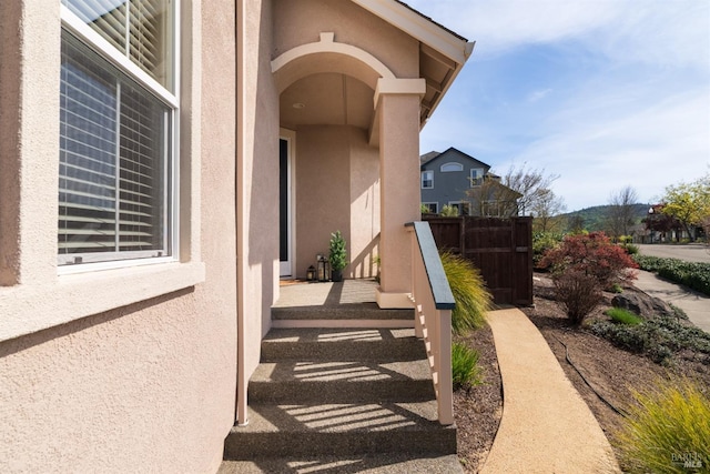 entrance to property featuring stucco siding