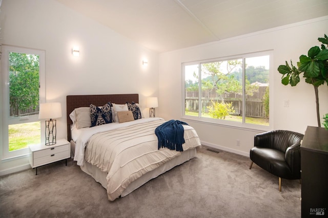 bedroom featuring vaulted ceiling, carpet flooring, visible vents, and baseboards