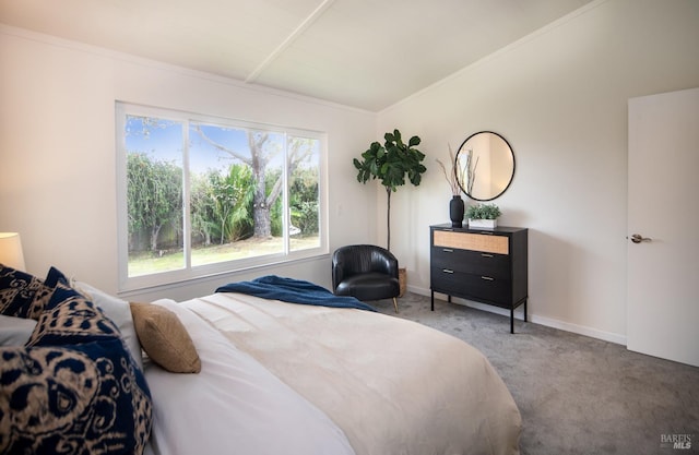 carpeted bedroom featuring crown molding, vaulted ceiling, and baseboards