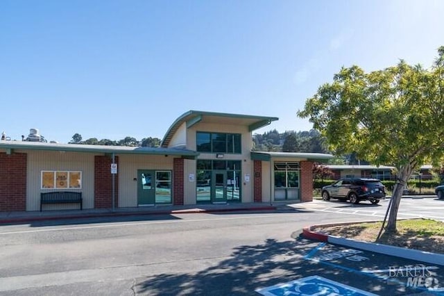 view of building exterior featuring uncovered parking