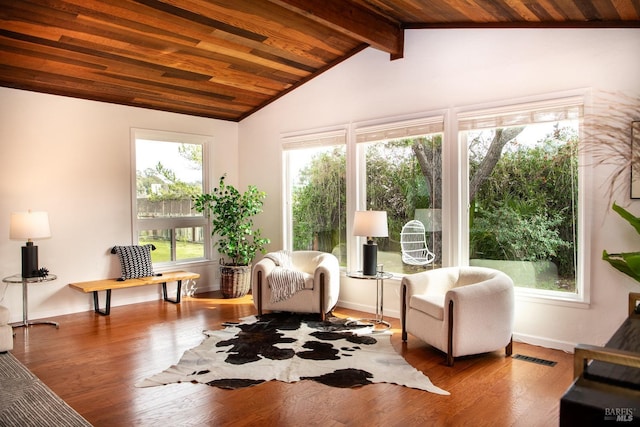 sunroom / solarium featuring lofted ceiling with beams, wooden ceiling, and visible vents