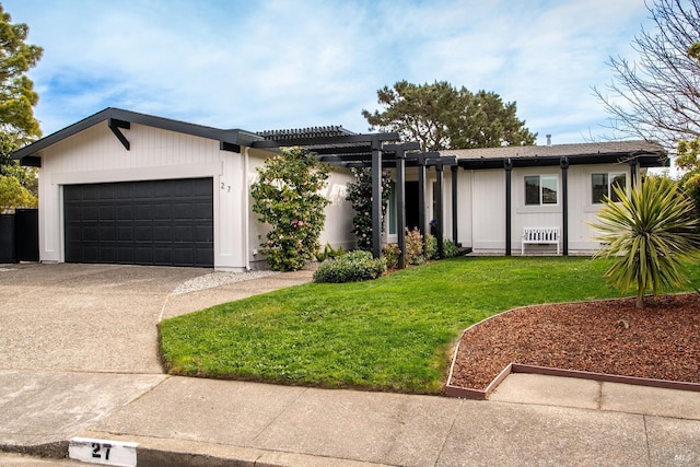 ranch-style house featuring an attached garage, a pergola, concrete driveway, and a front yard