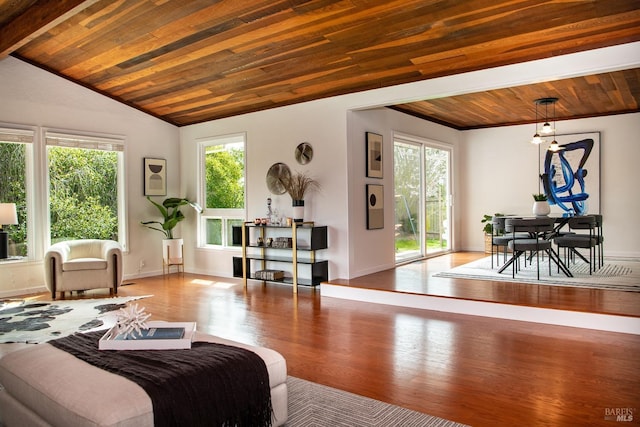 living area with lofted ceiling, wooden ceiling, baseboards, and wood finished floors