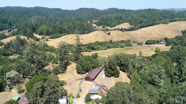 birds eye view of property featuring a wooded view