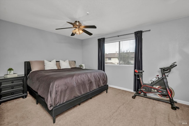bedroom featuring baseboards, ceiling fan, and carpet