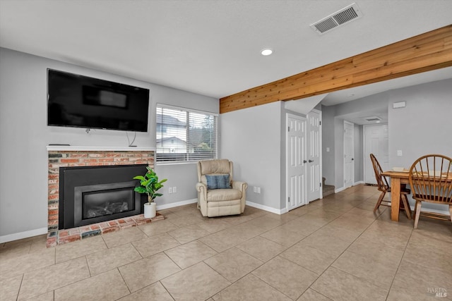 living area featuring visible vents, tile patterned flooring, a brick fireplace, baseboards, and recessed lighting