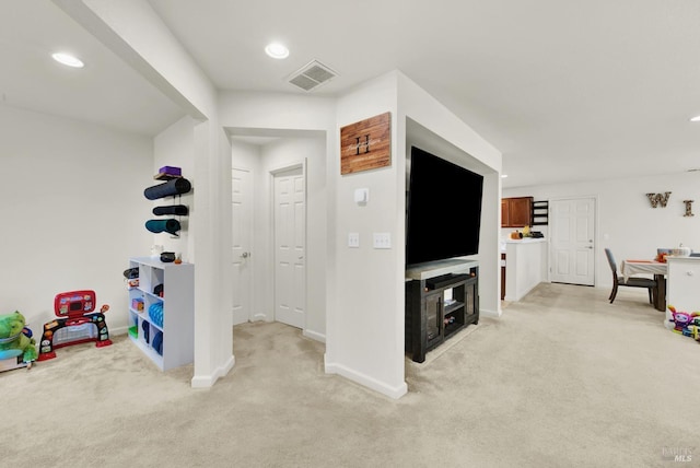 rec room with recessed lighting, light carpet, visible vents, and baseboards