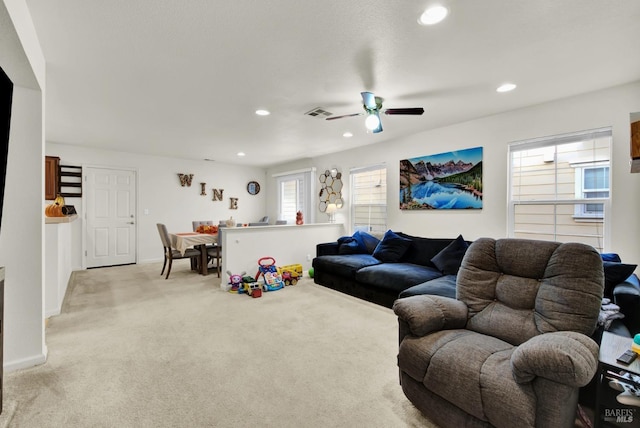 living area with recessed lighting, light colored carpet, and baseboards
