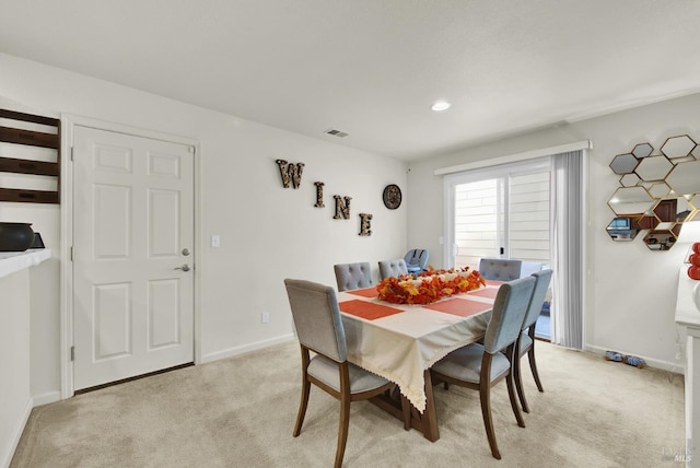 dining area featuring light carpet, baseboards, and visible vents