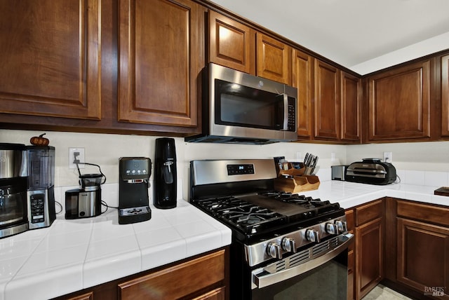kitchen with stainless steel appliances and tile counters