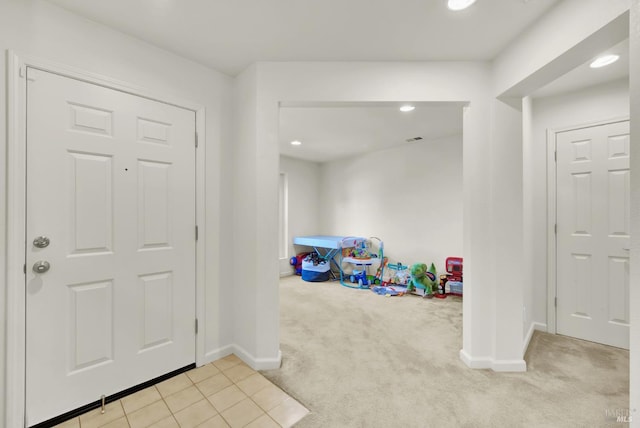 foyer featuring recessed lighting, visible vents, baseboards, and light colored carpet
