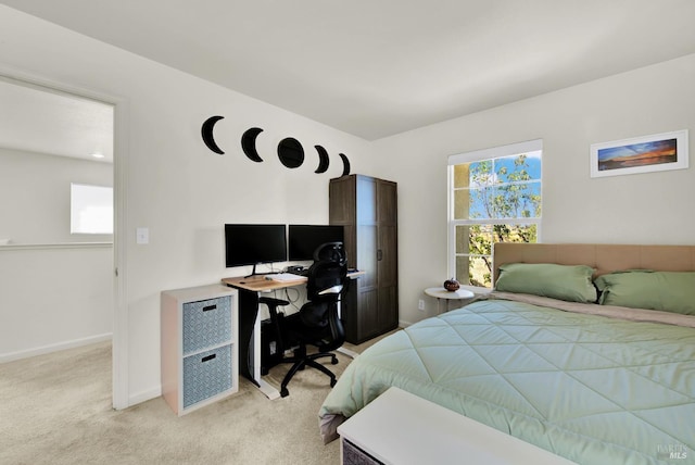 bedroom featuring light carpet and baseboards