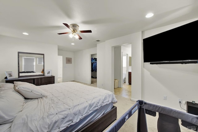 bedroom featuring visible vents, a ceiling fan, light colored carpet, a walk in closet, and recessed lighting