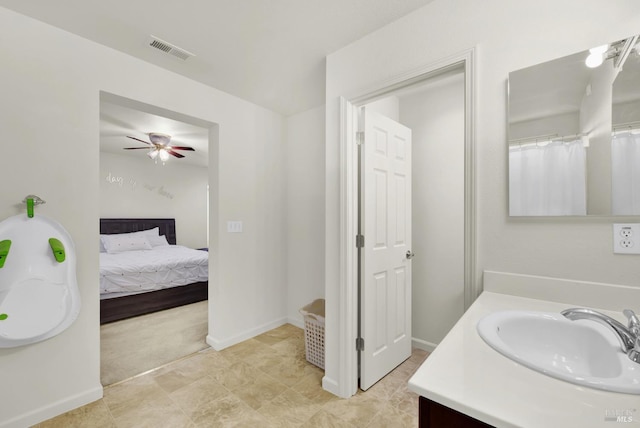 bathroom with visible vents, connected bathroom, vanity, ceiling fan, and baseboards