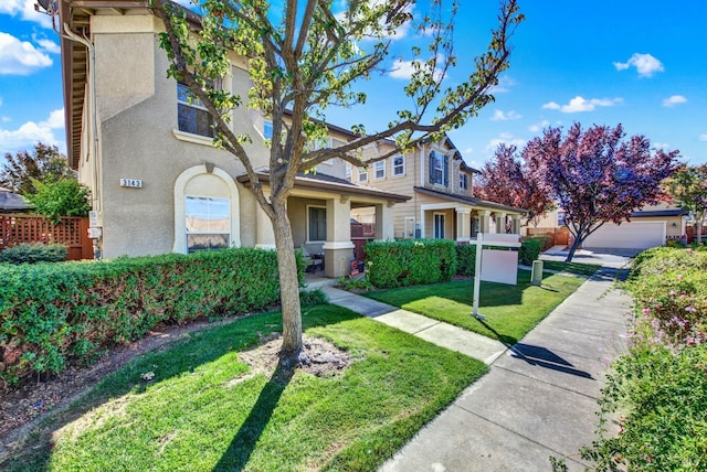view of front of property featuring a front lawn and stucco siding