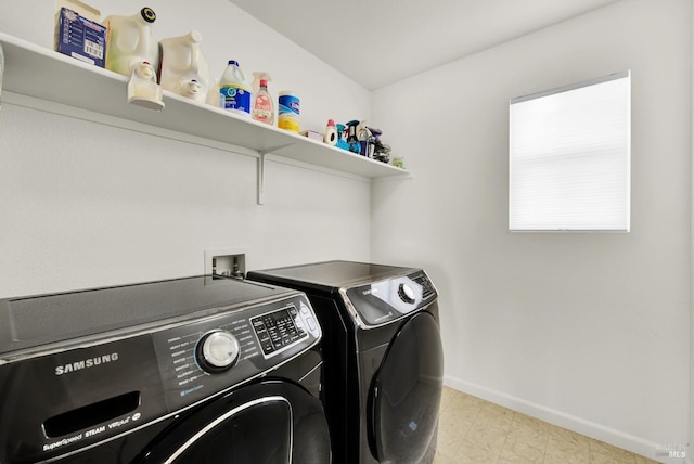 laundry area with washing machine and dryer, laundry area, and baseboards