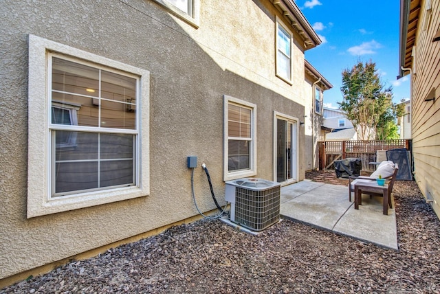 view of patio / terrace featuring fence and central AC unit