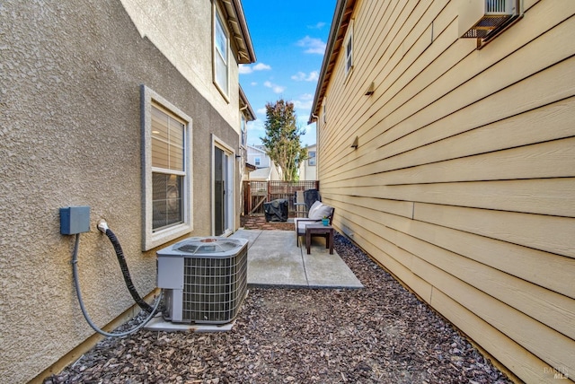 exterior space featuring central AC unit and fence