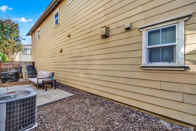view of home's exterior featuring a patio, central AC unit, and fence