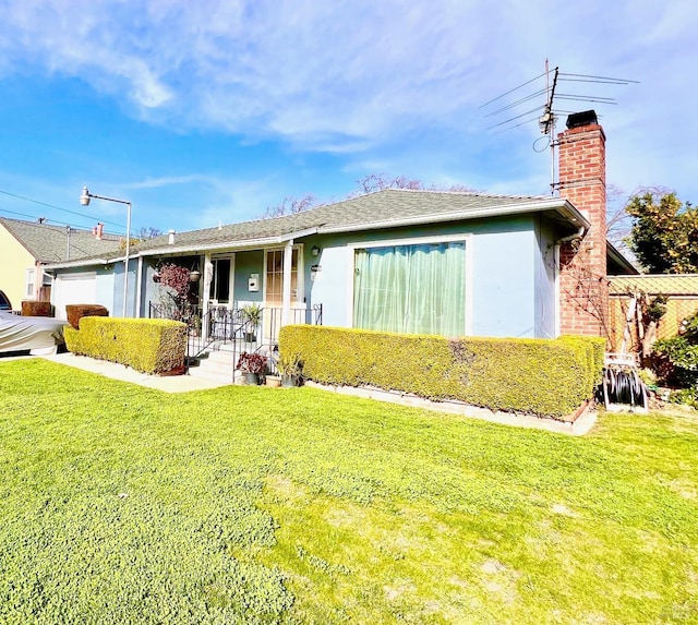 ranch-style house featuring a chimney, a front lawn, and stucco siding