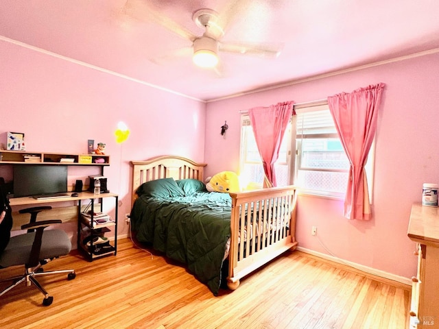 bedroom with wood finished floors, a ceiling fan, and baseboards