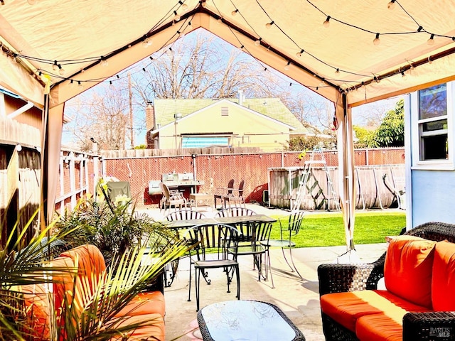 view of patio / terrace featuring outdoor dining area, a fenced backyard, and an outdoor living space