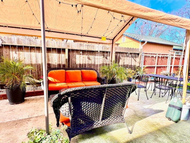 view of patio / terrace featuring fence and an outdoor living space