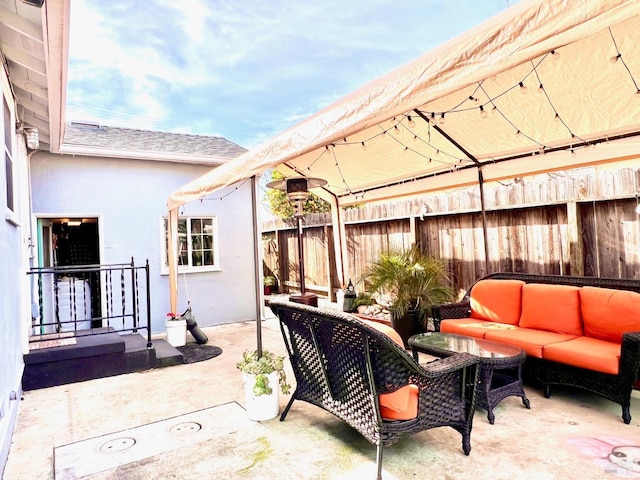 view of patio / terrace featuring an outdoor hangout area and fence