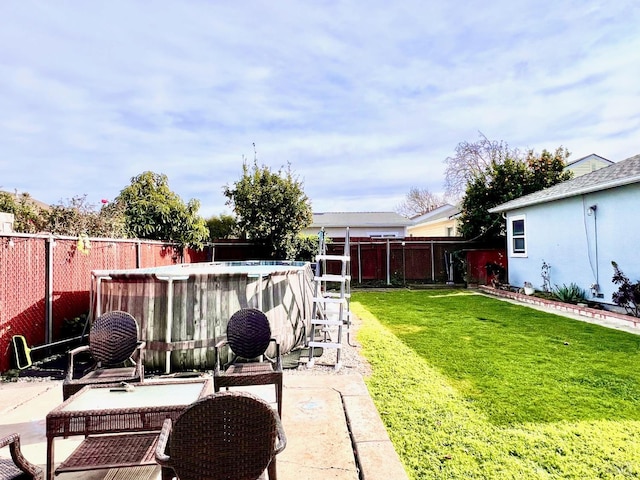 view of yard featuring a patio area, a fenced backyard, and a fenced in pool